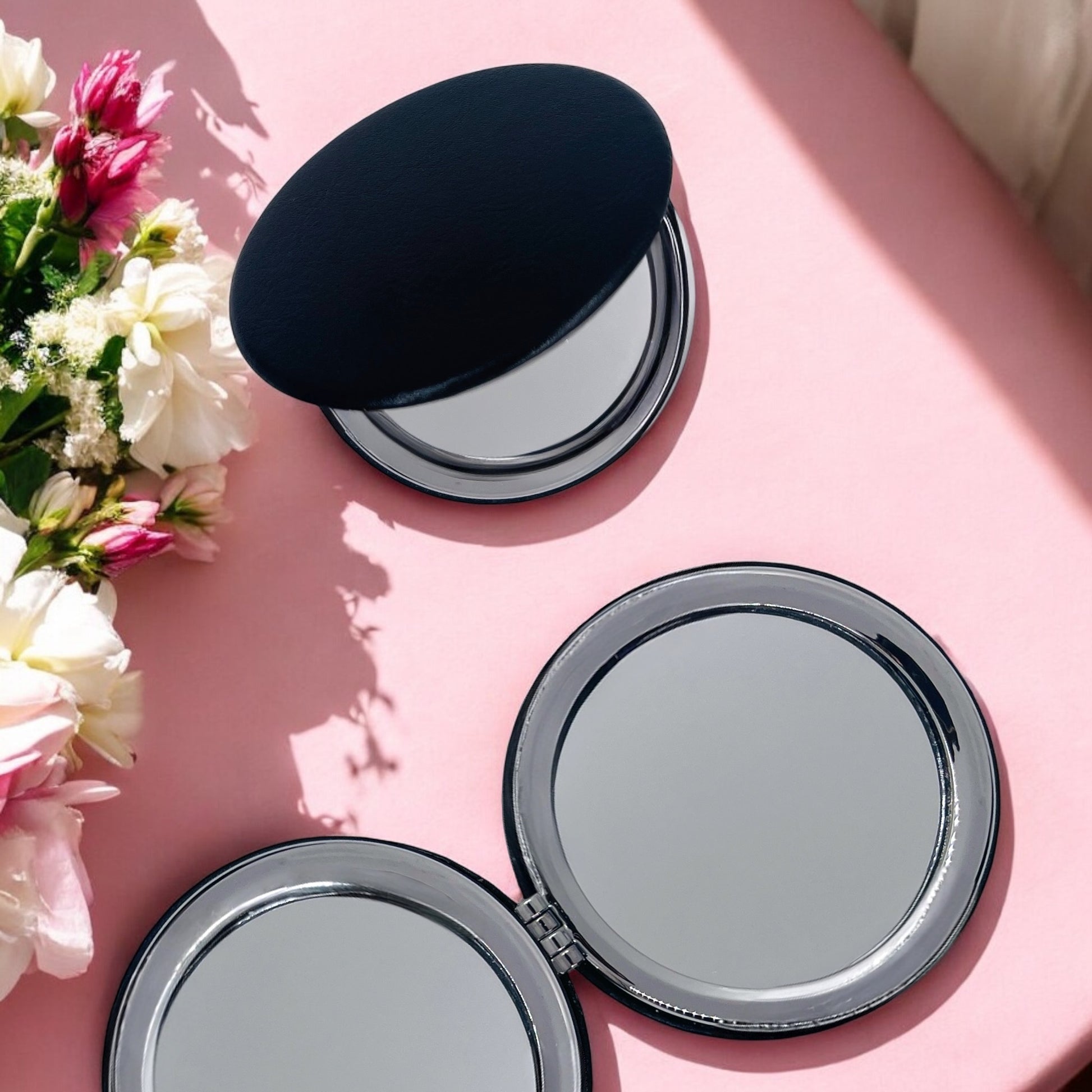 Dabble Doll motivational gift set for her featuring compact mirrors on a pink surface with fresh flowers