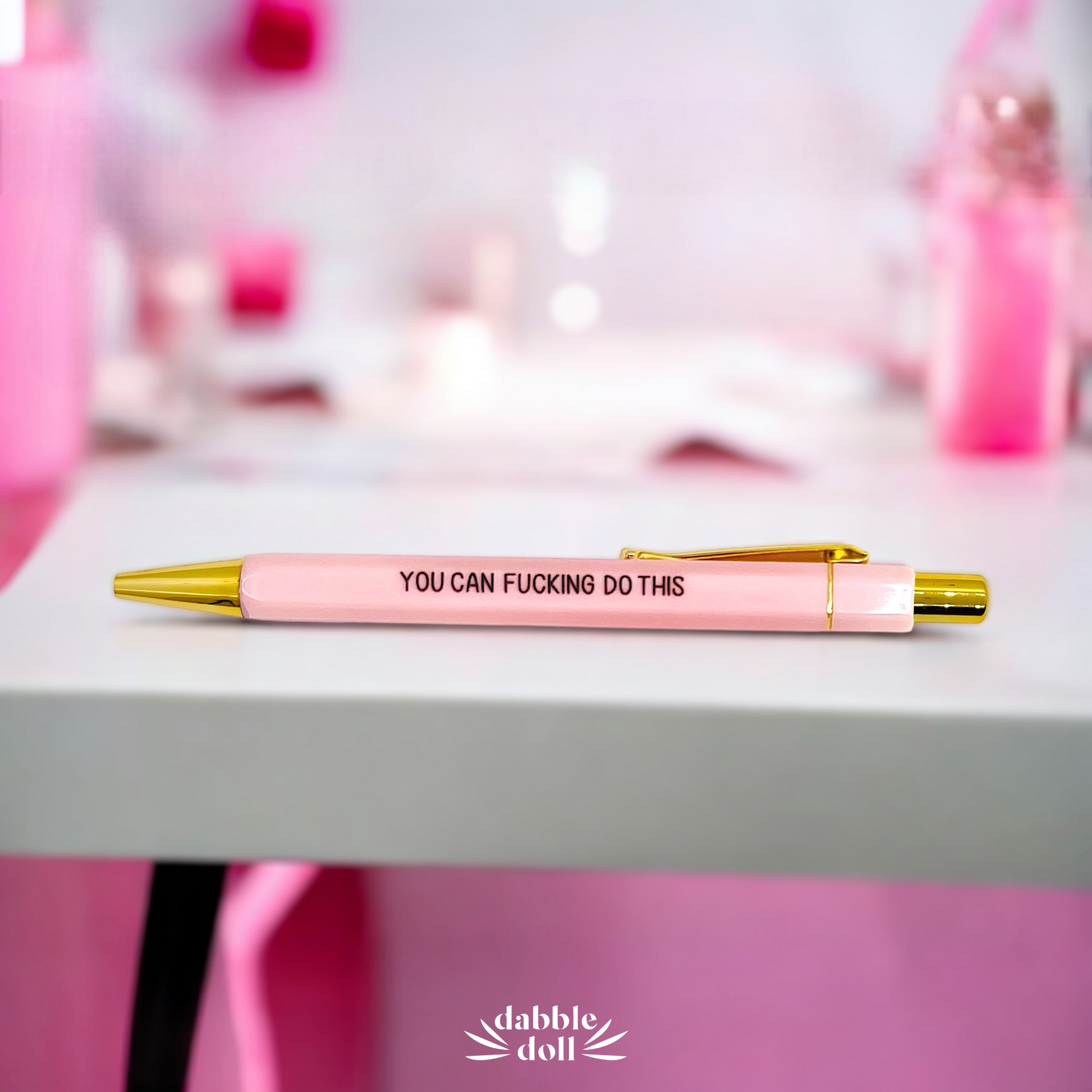 Dabble Doll pink pen with gold accents motivational gift set for her on white surface