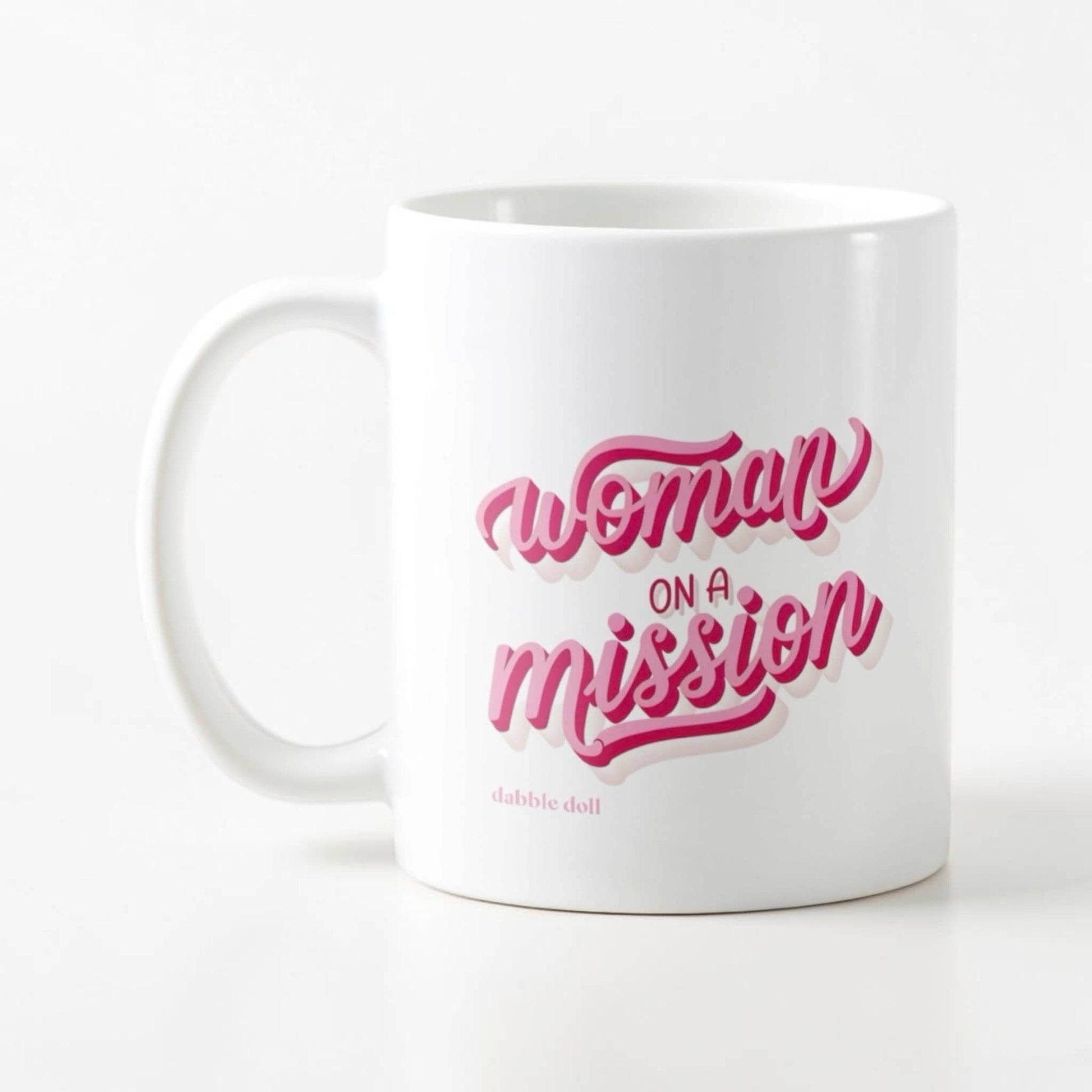 Dabble Doll novelty mug with 'Woman on a Mission' design in pink and white colors