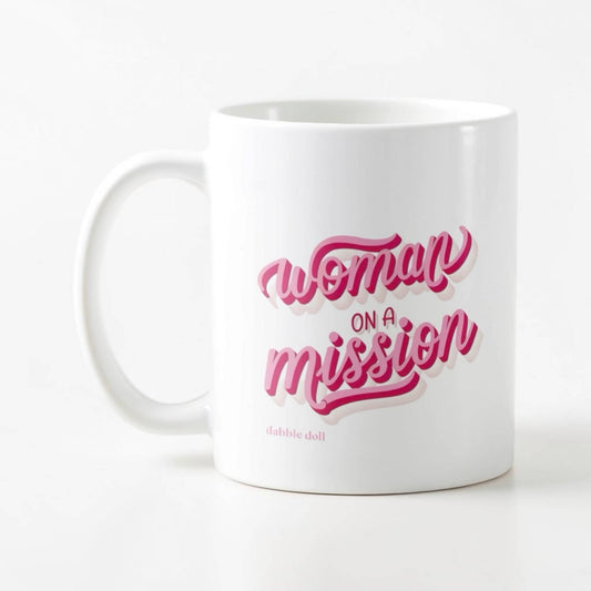 Dabble Doll novelty mug with 'Woman on a Mission' design in pink and white colors