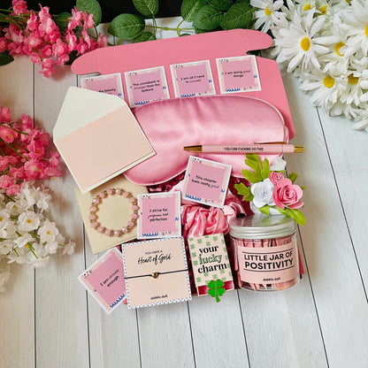 Dabble Doll positivity care package gift box with sleep mask, bracelet, jar of positivity, flowers, and motivational cards
