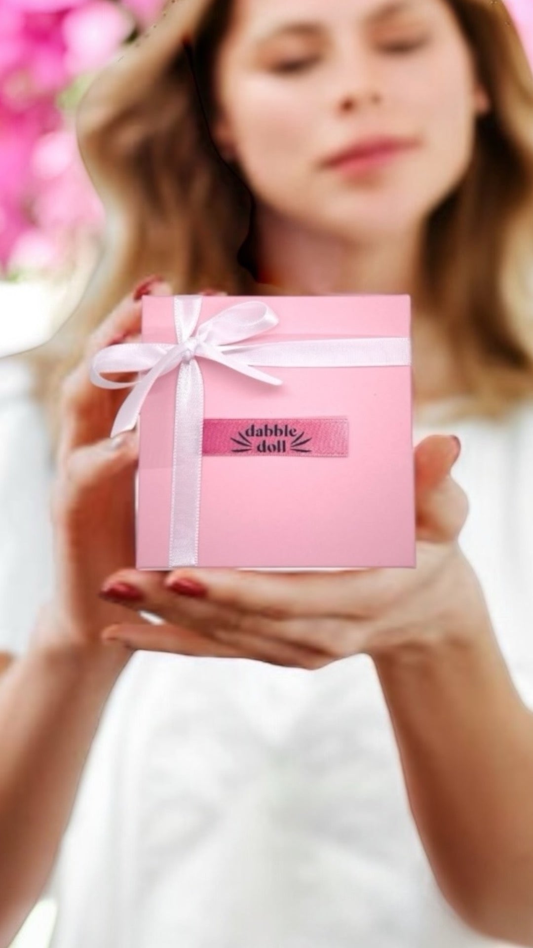 Dabble Doll gift box featuring cozy Socks wrapped in pink with a ribbon for stylish comfort