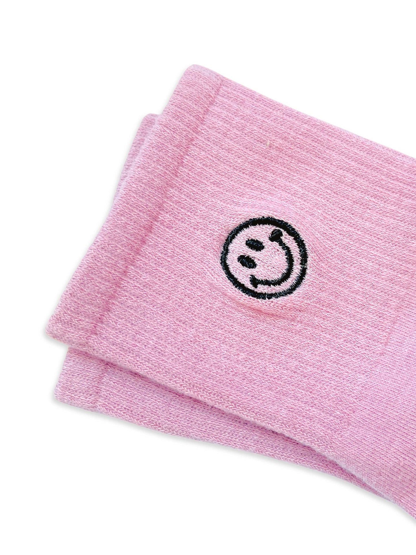 Dabble Doll pink socks with a smiley face design for a cheerful and cozy look