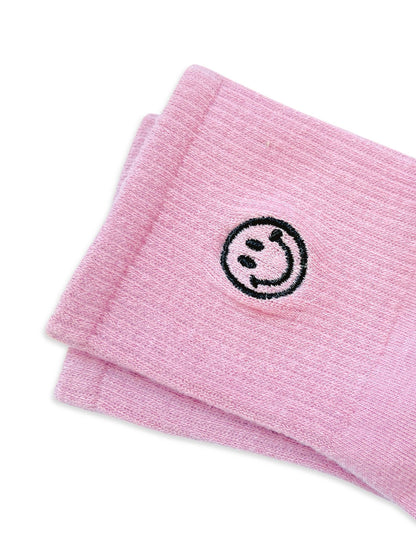 Dabble Doll pink socks with a smiley face design for a cheerful and cozy look