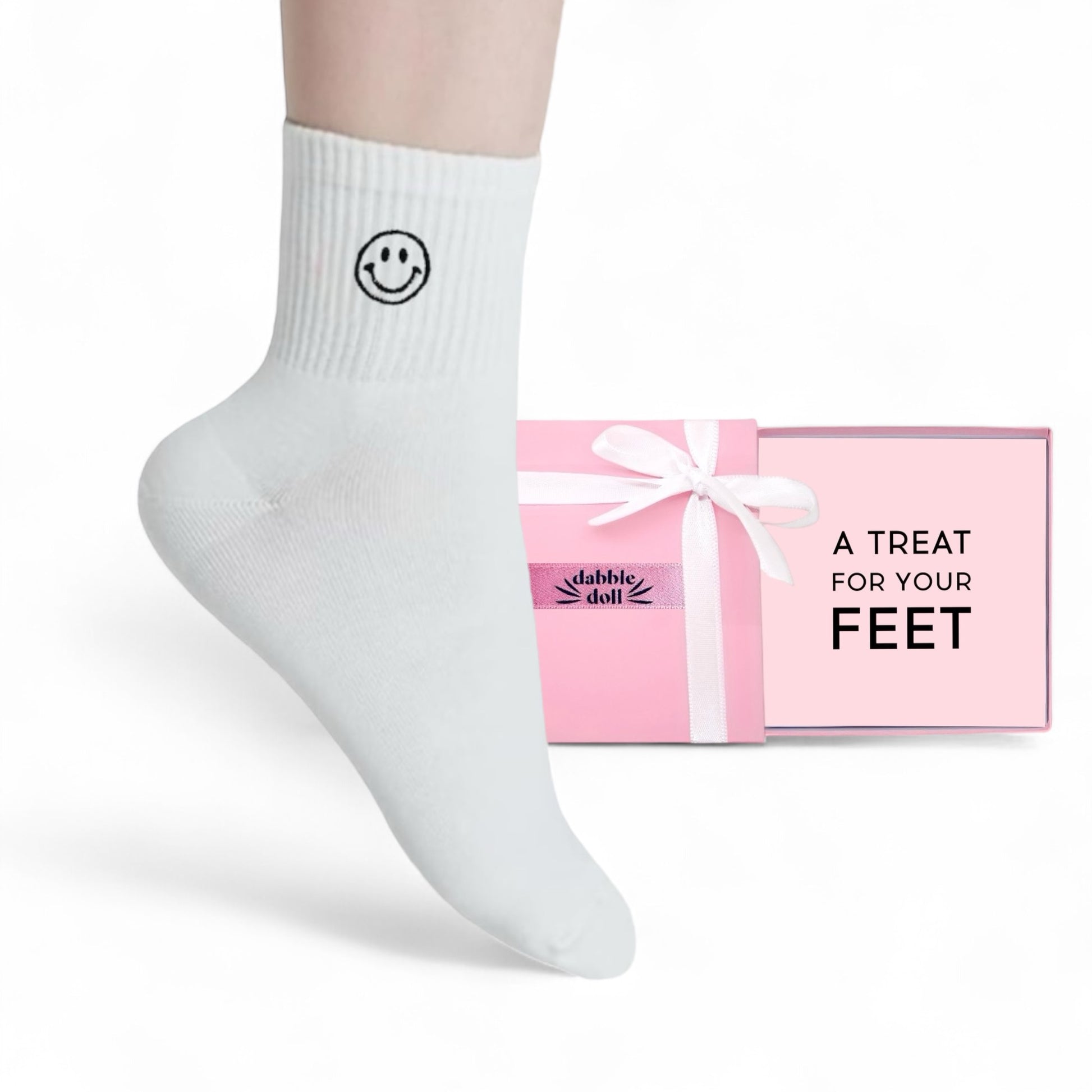 Dabble Doll Gift Box with Pink Packaging and White Socks featuring a Smiley Face for Girls and Women