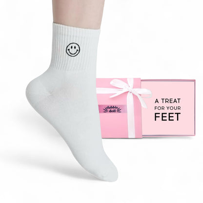 Dabble Doll Gift Box with Pink Packaging and White Socks featuring a Smiley Face for Girls and Women