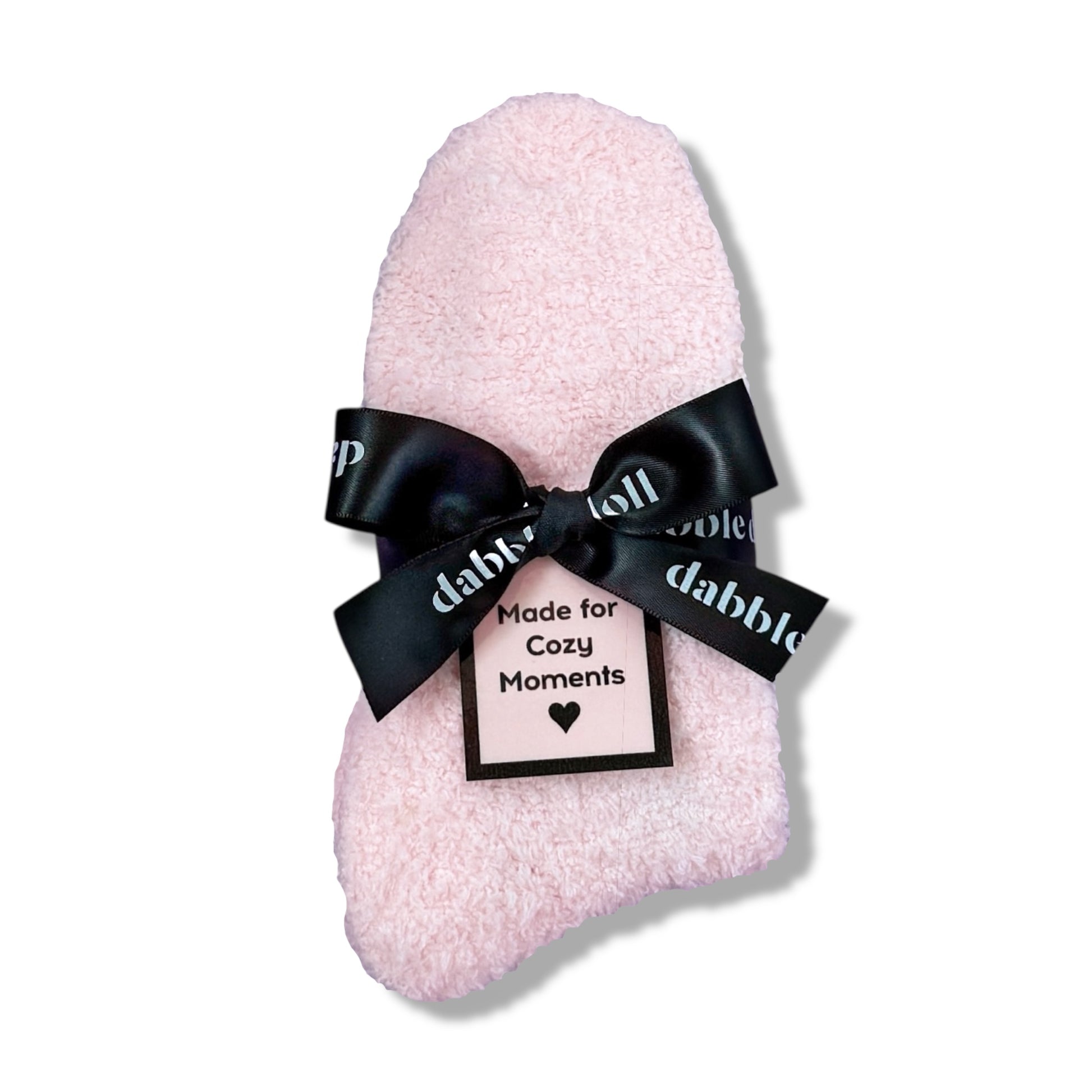 Dabble Doll Gift Box featuring fluffy socks tied with a black ribbon for cozy moments
