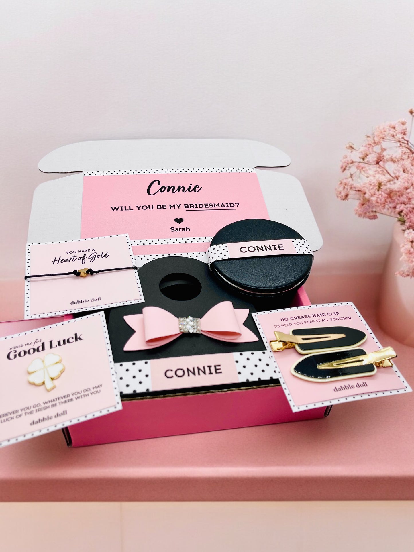 Dabble Doll pink gift box for women featuring hair accessories and personalized cards for bridesmaids
