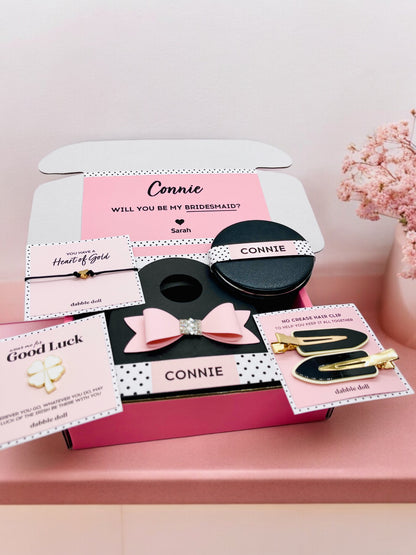 Dabble Doll pink gift box for women featuring hair accessories and personalized cards for bridesmaids