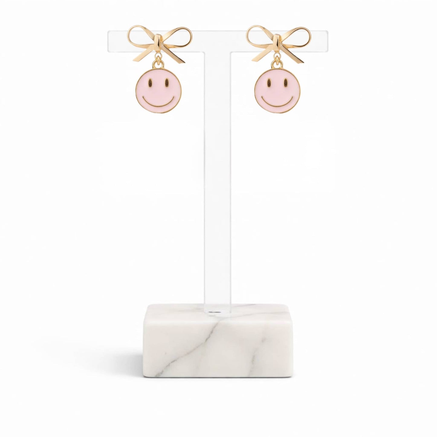Dabble Doll pink smiley face earrings with gold bow accents for a cheerful accessory