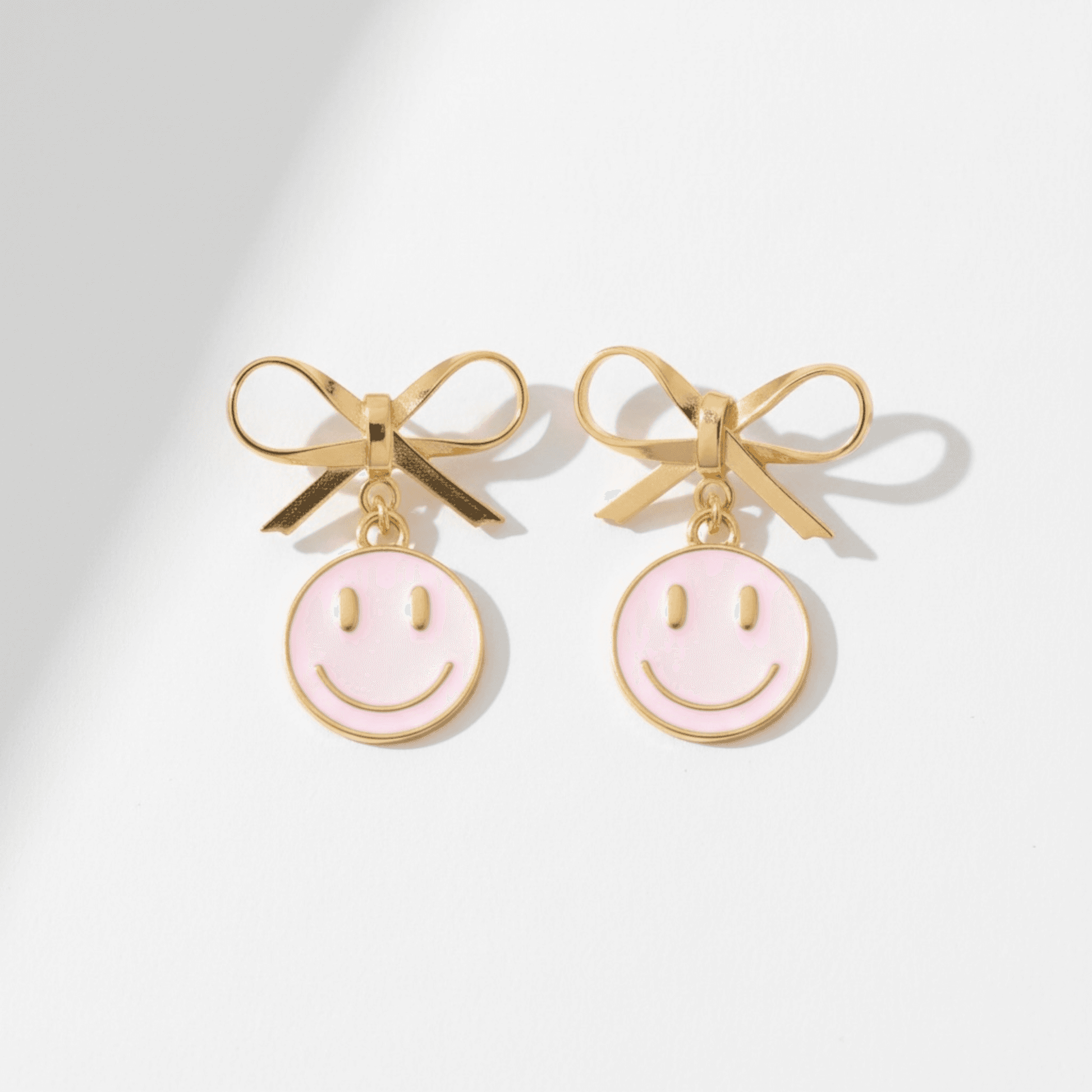 Dabble Doll Pink Smiley Face Earrings with Gold Bow Detail for a Fun Look