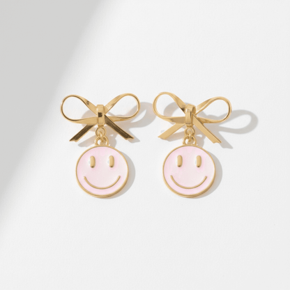 Dabble Doll Pink Smiley Face Earrings with Gold Bow Detail for a Fun Look