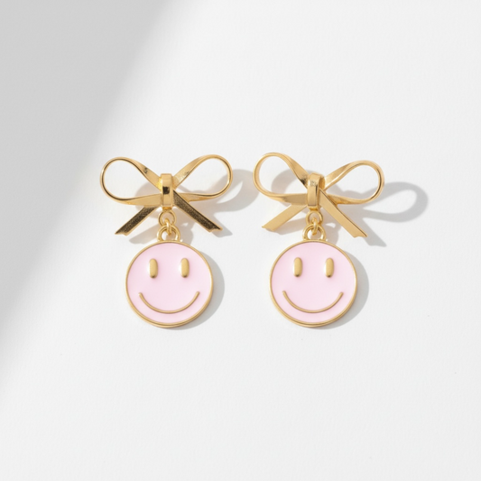 Dabble Doll Pink Smiley Face Earrings with Gold Bow Detail for a Fun Look