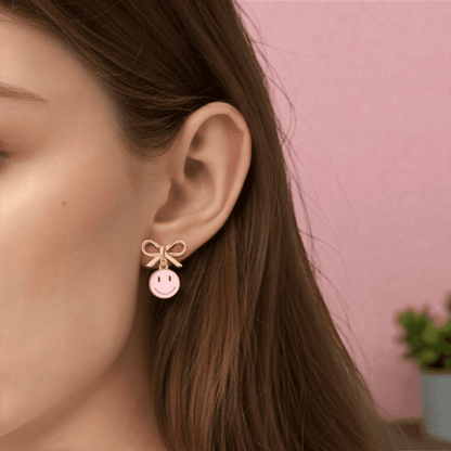 Dabble Doll Smiley Face Earrings with Pink Smiley Charm and Bow for a Playful Touch