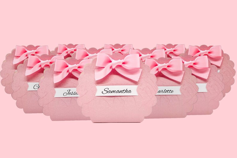 Pink favor box with scalloped edges and bow, perfect for girls and women's events