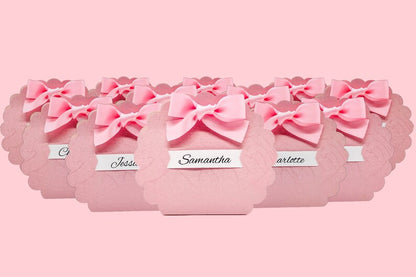 Pink favor box with scalloped edges and bow, perfect for girls and women's events