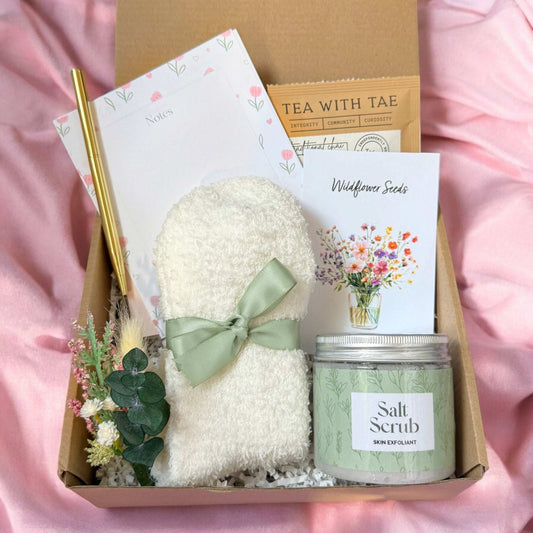 Dabble Doll fluffy socks and tea gift box with cozy socks, tea bag, salt scrub, floral notes, and wildflower seeds
