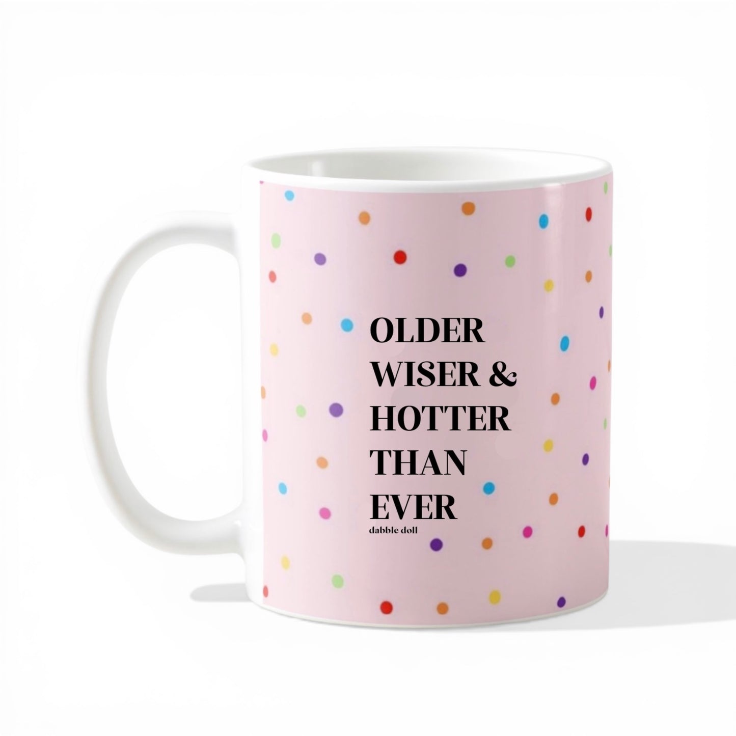 Dabble Doll gift box featuring a funny coffee mug with colorful dots and the phrase Older Wiser & Hotter Than Ever