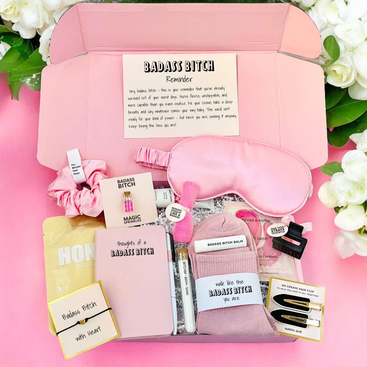 Pink Dabble Doll gift box filled with self-care items for girls and women, including a sleep mask and accessories