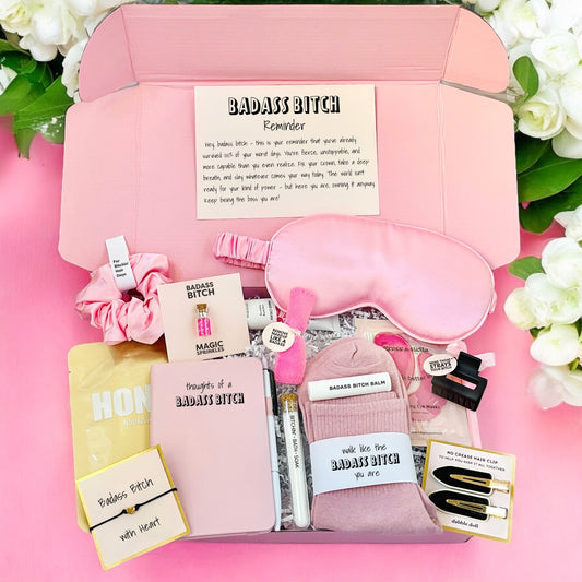 Pink Dabble Doll gift box filled with self-care items for girls and women, including a sleep mask and accessories
