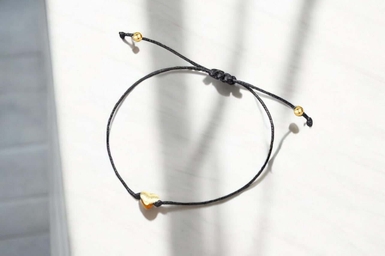 Elegant black gift box containing a bracelet for girls with gold accents and adjustable closure