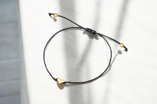 Elegant black gift box containing a bracelet for girls with gold accents and adjustable closure