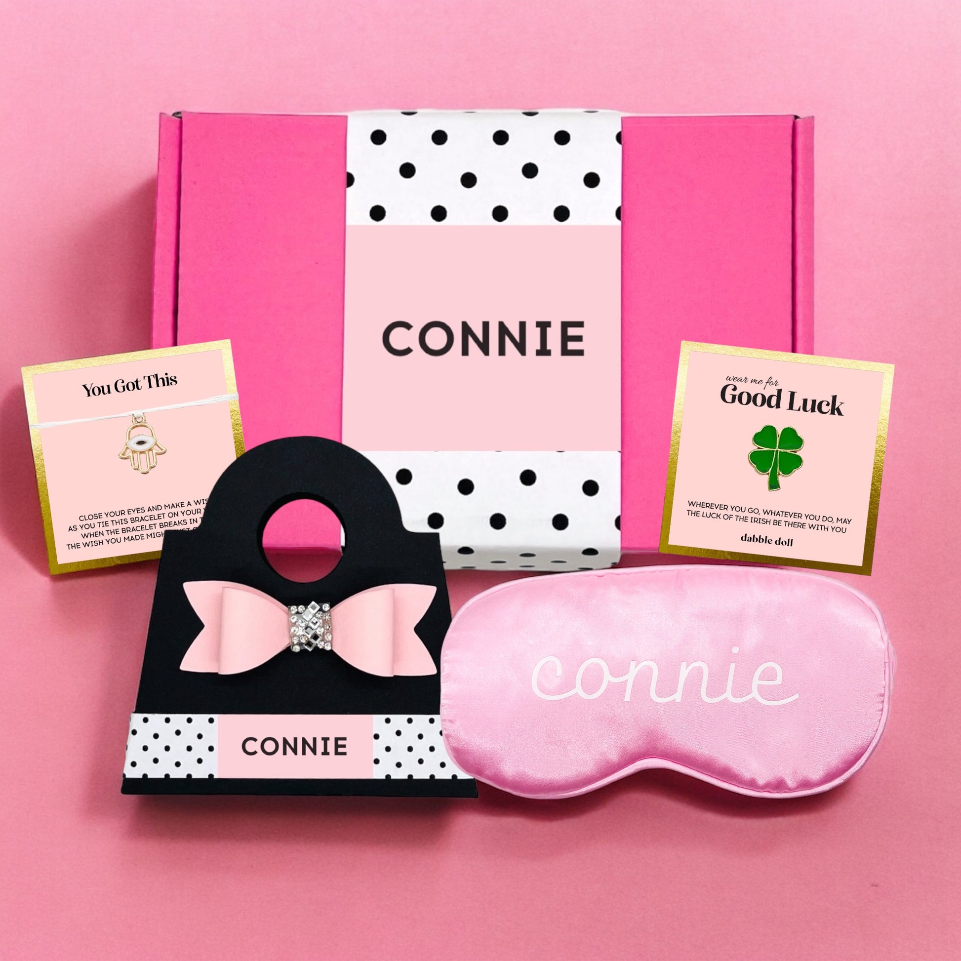 Personalized pink gift box for girls featuring a sleep mask and motivational cards from Dabble Doll