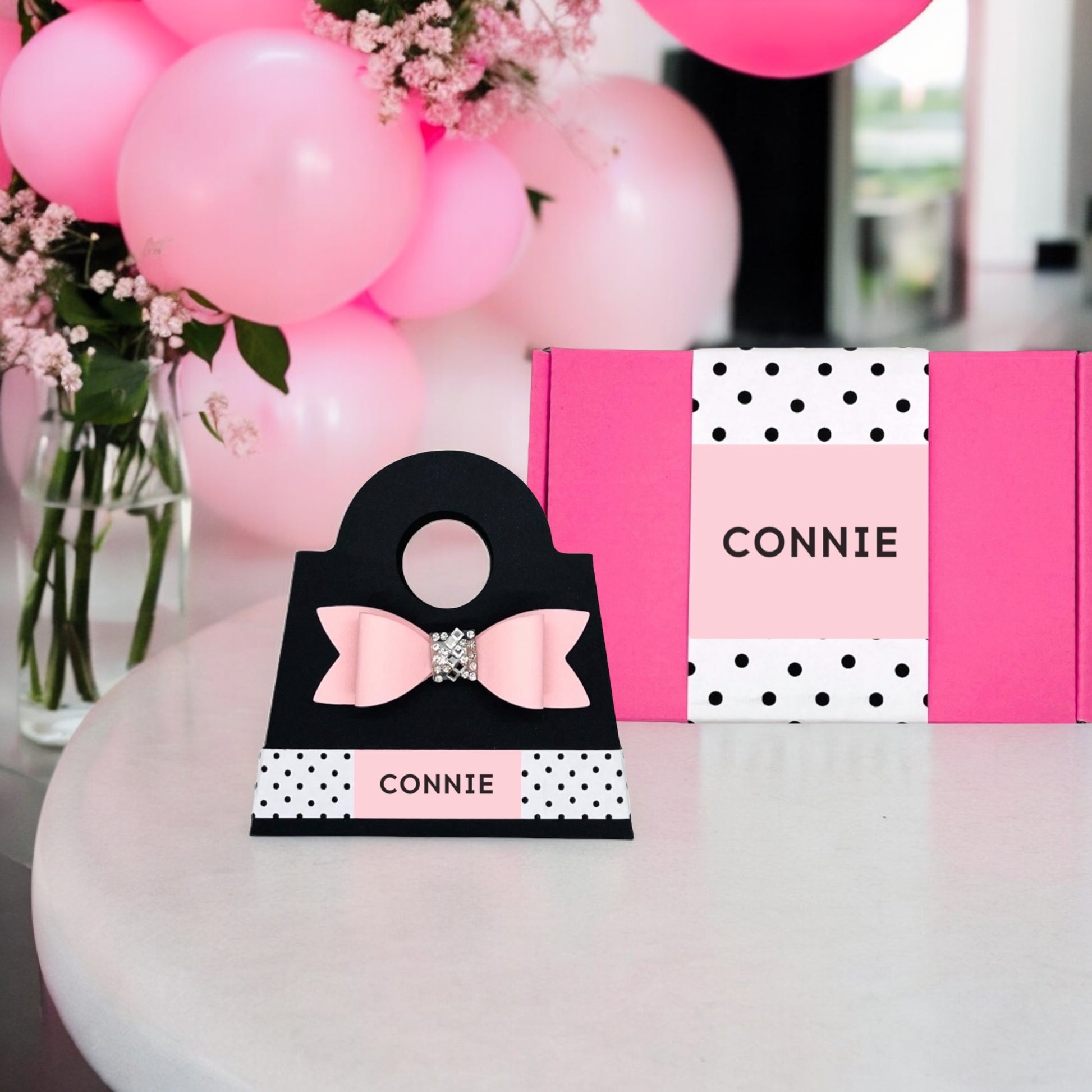 Pink and black gift box for girls and women, adorned with a bow and sparkly detail, perfect for special occasions