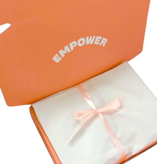 Dabble Doll Gift Box in pastel orange with empowering message, perfect for girls and women.