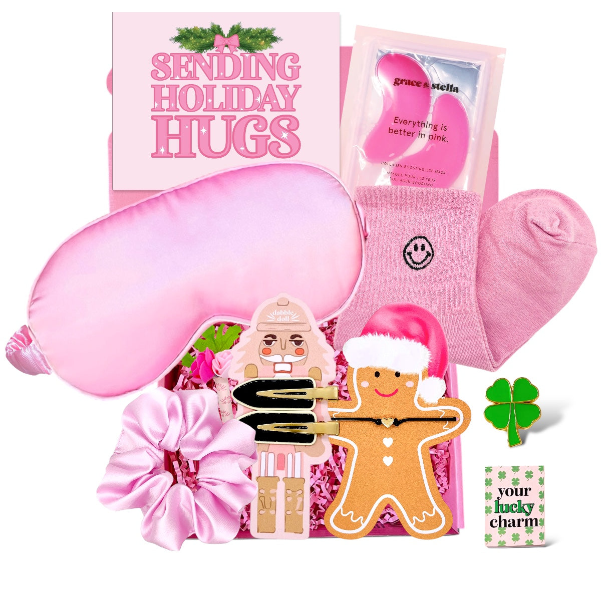 Pink gift box for girls featuring holiday themed items like a sleep mask, socks, and gingerbread accessories