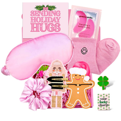 Pink gift box for girls featuring holiday themed items like a sleep mask, socks, and gingerbread accessories