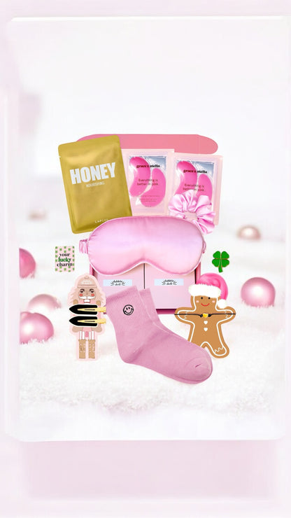Pink Dabble Doll Gift Box for women filled with a silk eye mask, cozy socks, and cute accessories