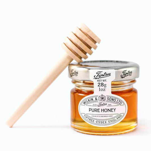 Dabble Doll gift box featuring a jar of golden pure honey and wooden honey dipper for ladies and girls