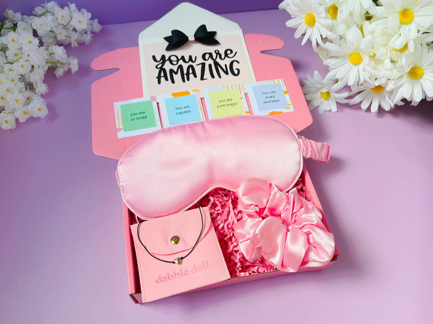 Pink gift box for girls featuring a sleep mask, scrunchies, and a necklace from Dabble Doll