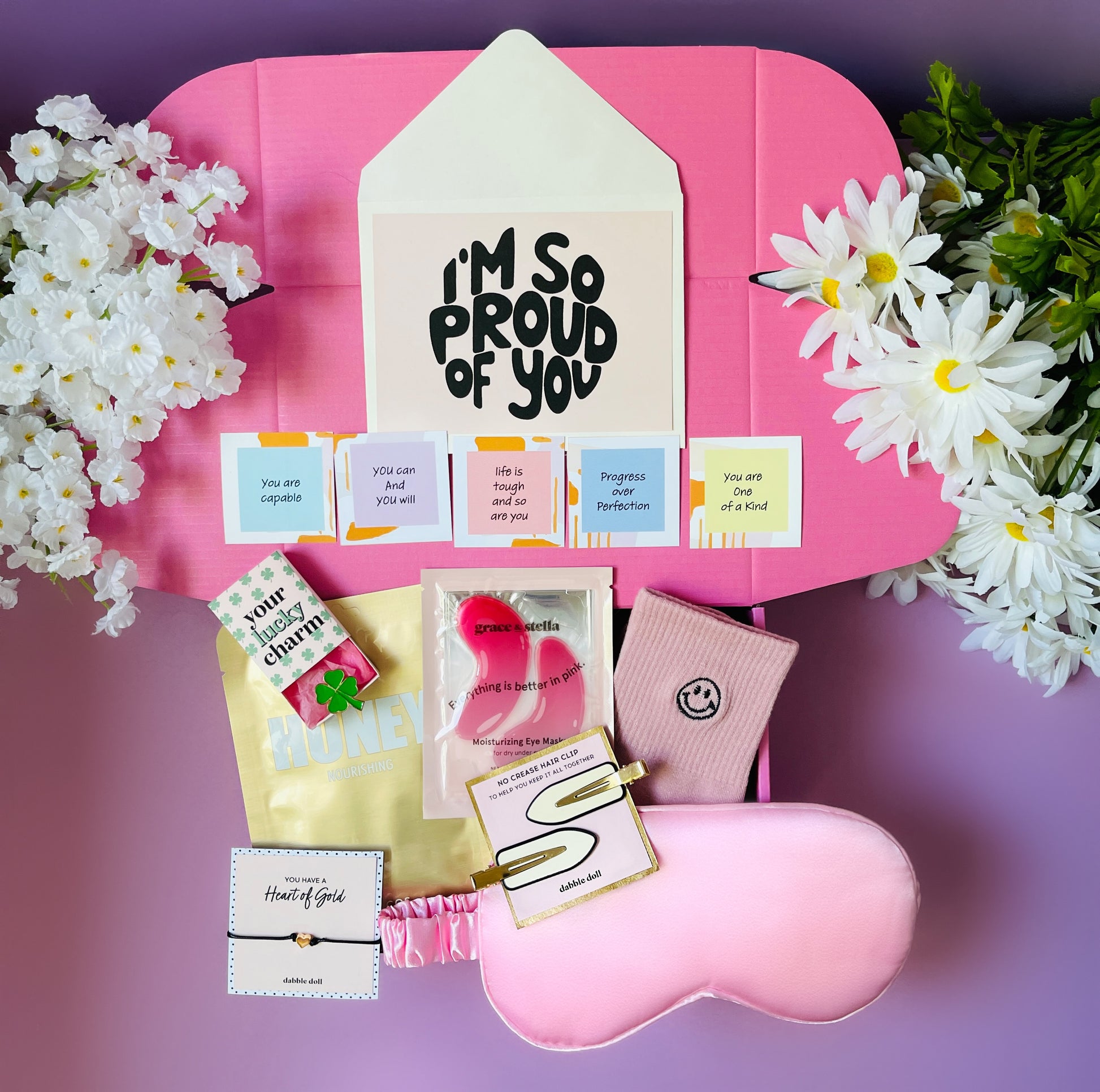 Pink Dabble Doll Gift Box for girls featuring self-care items, inspiring notes, and a sleep mask