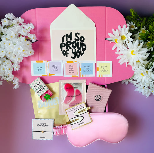 Pink Dabble Doll Gift Box for girls featuring self-care items, inspiring notes, and a sleep mask