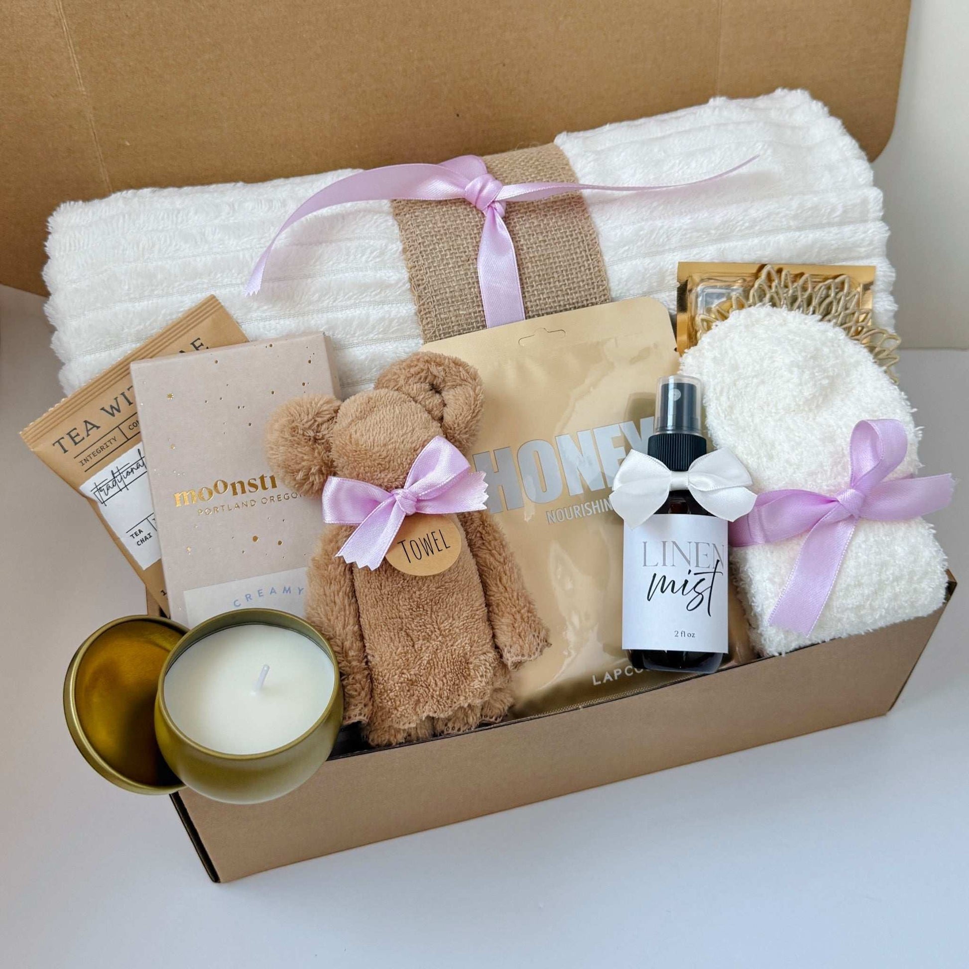 Dabble Doll gift box featuring soft towels, plush bear, candle, and pampering items for girls and women
