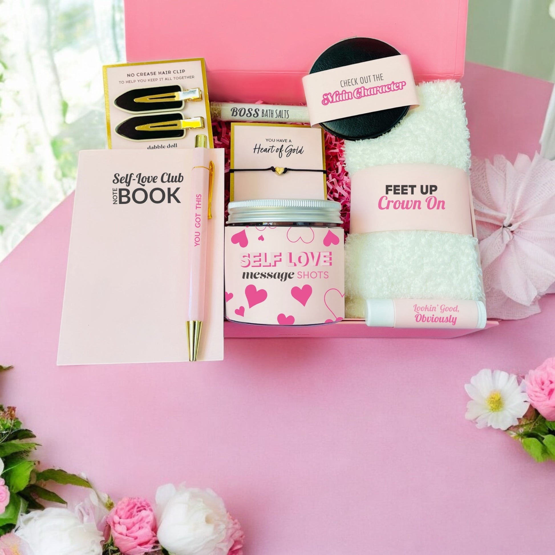 Pink gift box for girls featuring self-love items including a book, spa essentials, and decorative towel
