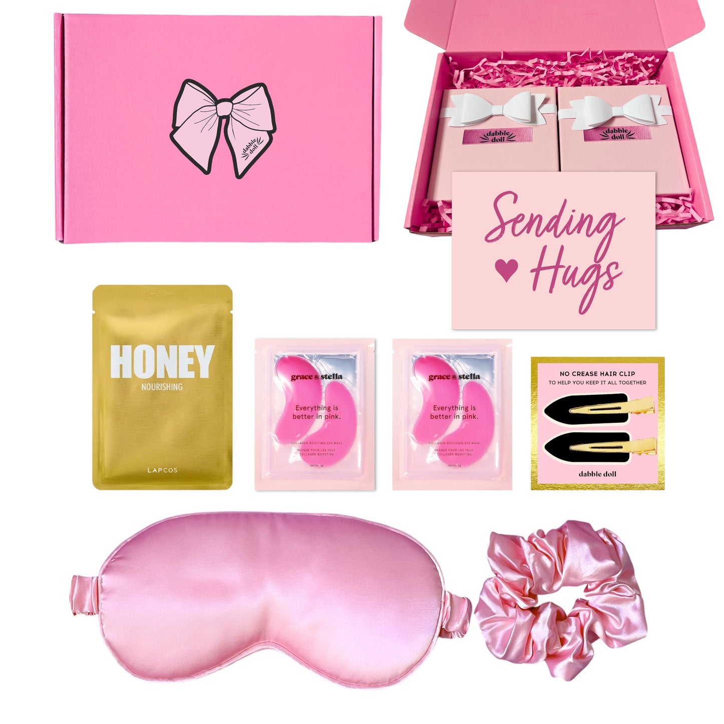 Pink gift box by Dabble Doll filled with luxurious items for girls and women, including a sleep mask and hair accessories