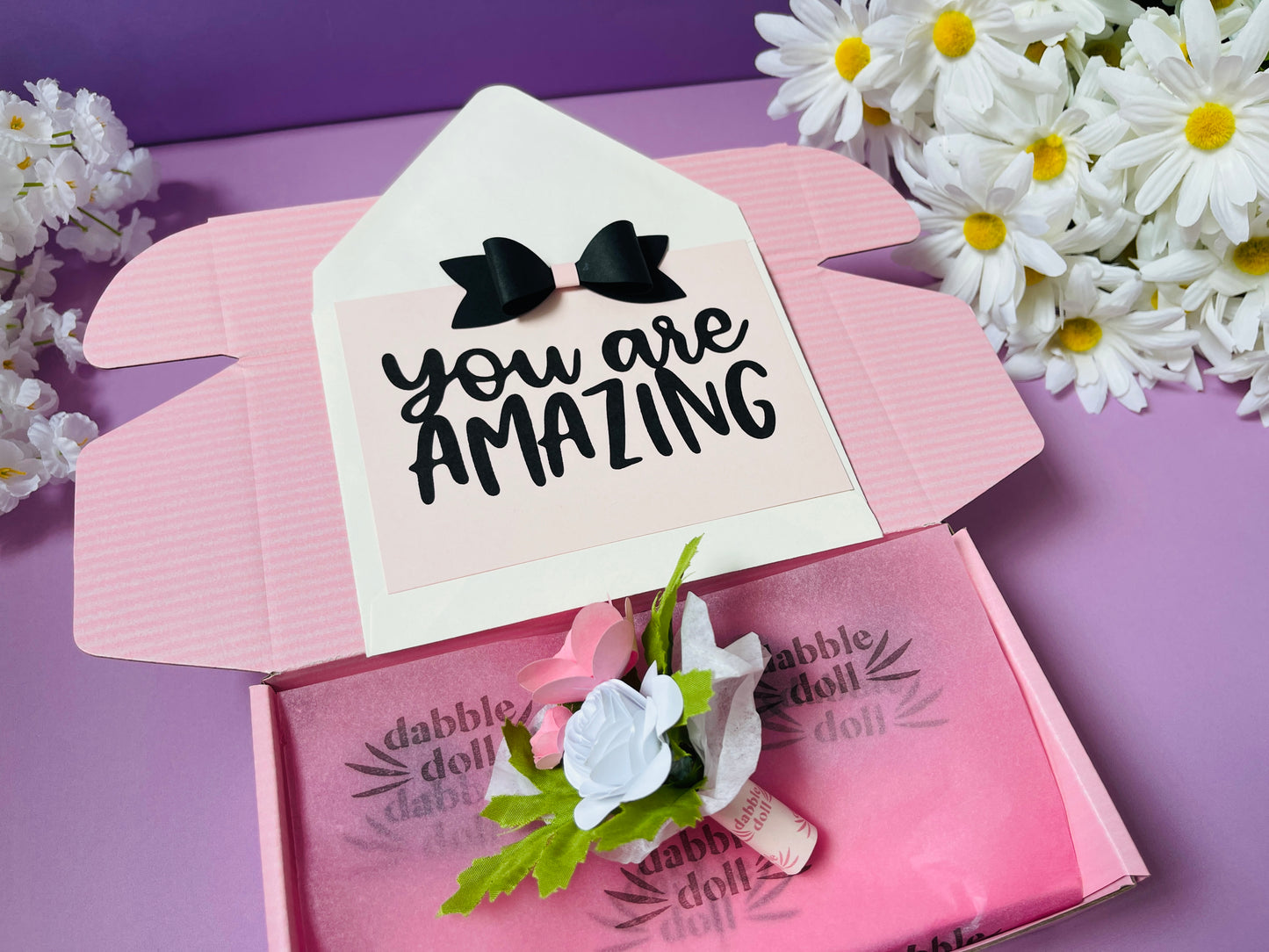Pink Dabble Doll gift box for girls featuring floral accents and a heartfelt message inside