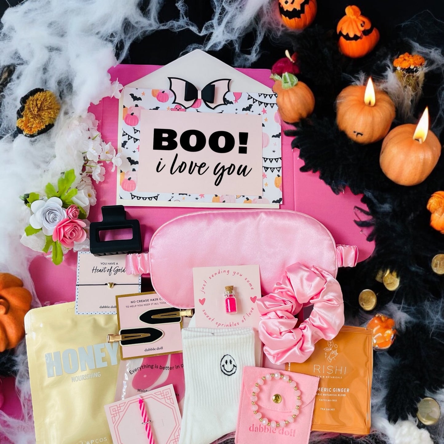 Pink gift in box for women featuring beauty products, accessories, and a festive theme