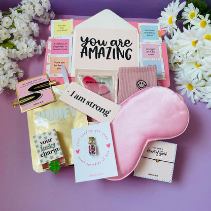 Pink gift in box for women featuring a sleep mask, charm, and inspirational cards