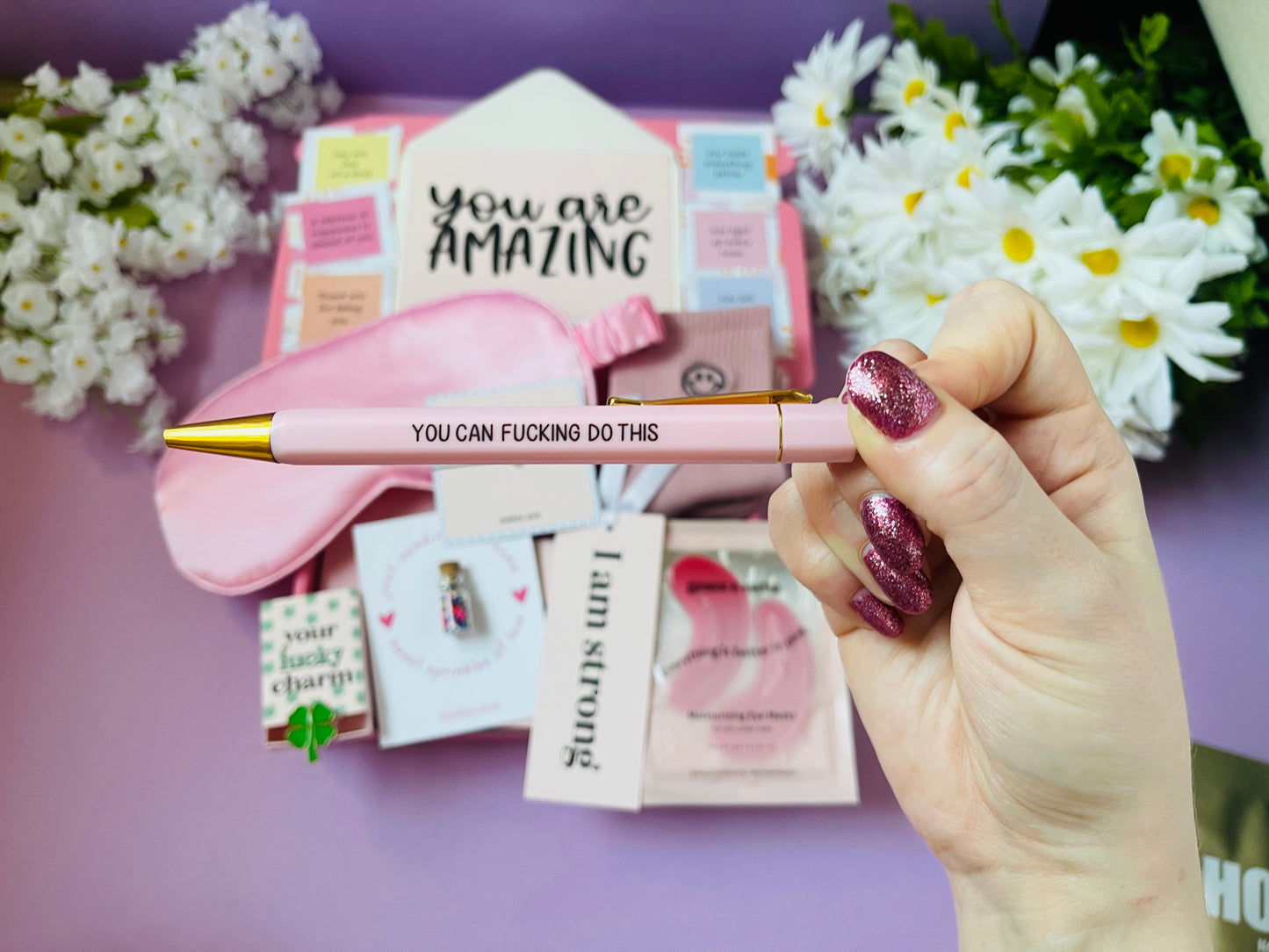 Dabble Doll gift in box for women featuring a pink pen, sleep mask, and motivational items