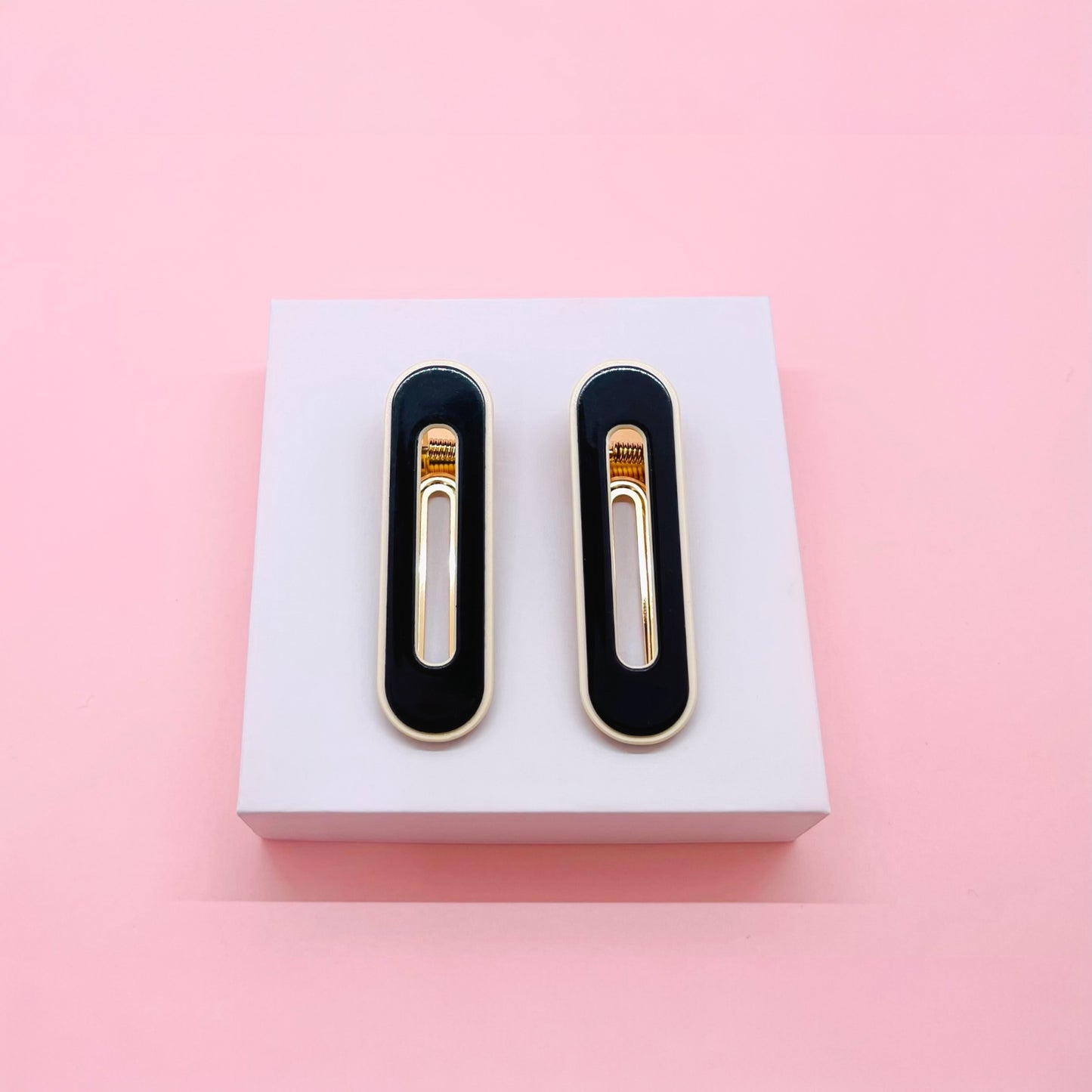 Black and gold Dabble Doll hair clips designed for girls and women, perfect for stylish hairstyles
