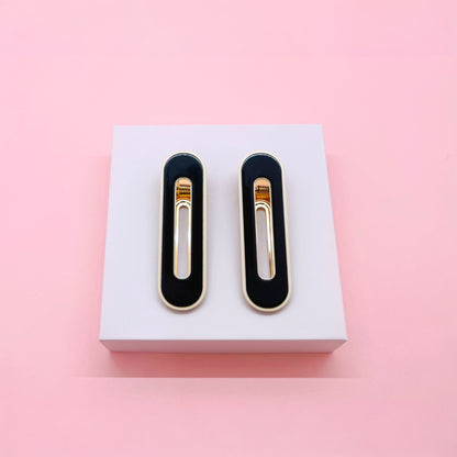 Black and gold Dabble Doll hair clips designed for girls and women, perfect for stylish hairstyles