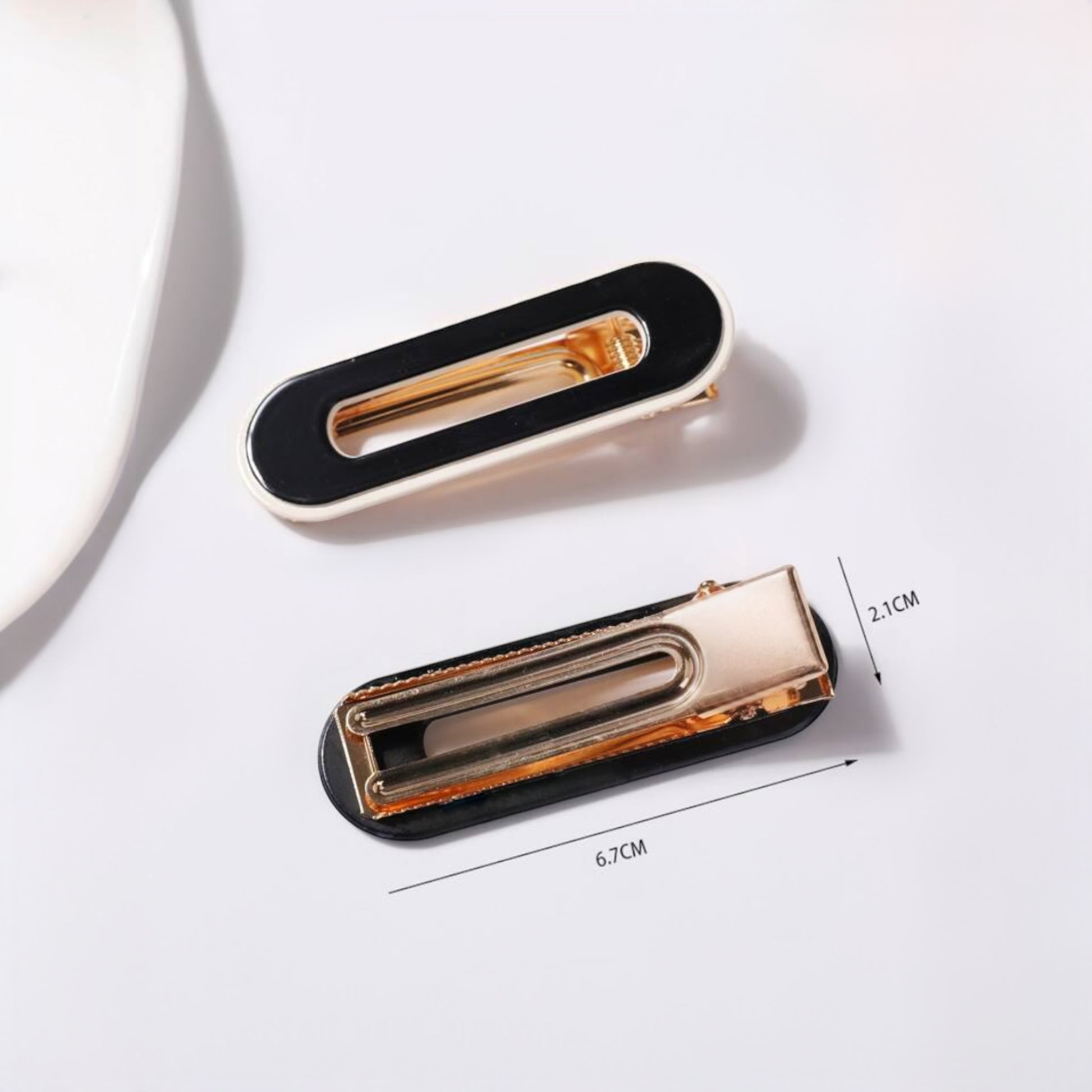 Elegant black and gold hair clips for girls and women, perfect for stylish hair accessories