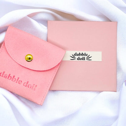 Pink Dabble Doll hair clips in a stylish pouch, perfect for girls and ladies