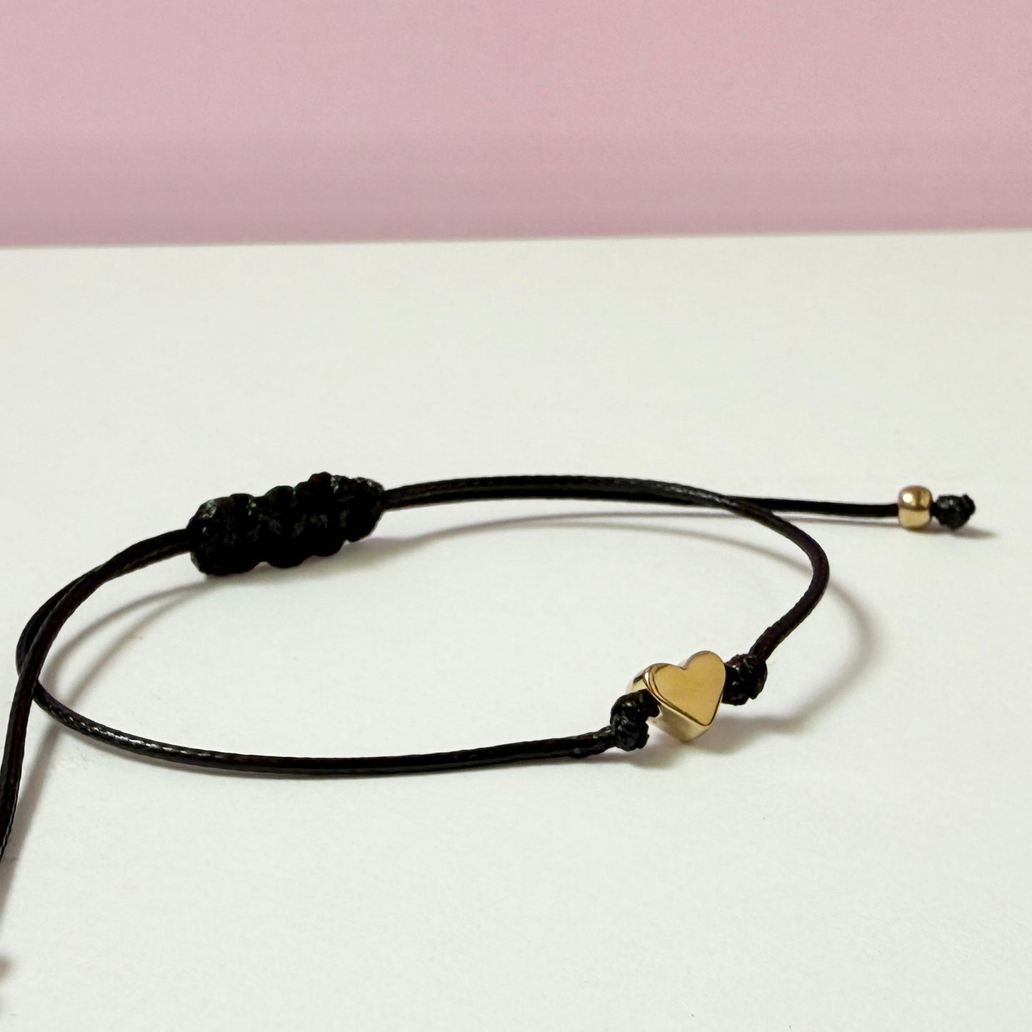 Black leather heart bracelet with a gold heart charm, perfect for girls and women