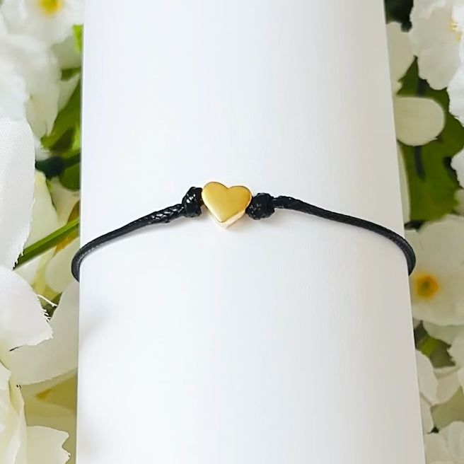 Dabble Doll heart bracelet in black cord with a small gold heart charm, perfect for girls and women