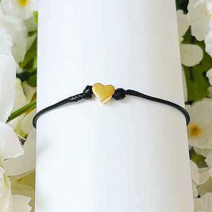 Dabble Doll heart bracelet in black cord with a small gold heart charm, perfect for girls and women